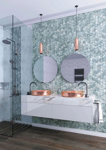 A bathroom with a marble countertop and two round mirrors Description automatically generated