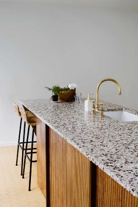 A counter top with a sink and stools Description automatically generated